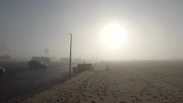 HUNTINGTON BEACH CALIFORNIA-2019: Foggy Sun Sets Down On The Sand At The Beach