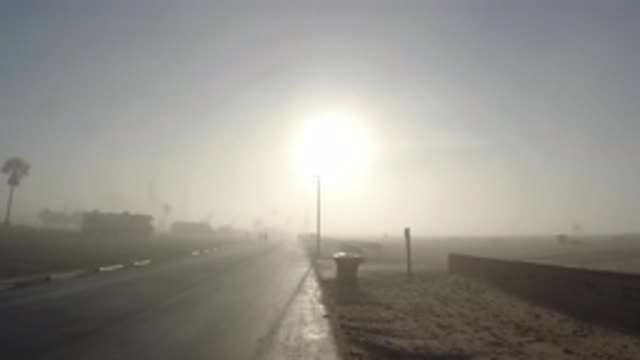 HUNTINGTON BEACH CALIFORNIA-2019: Blinding Sun On A Clear Dry Beach Road With Jogger