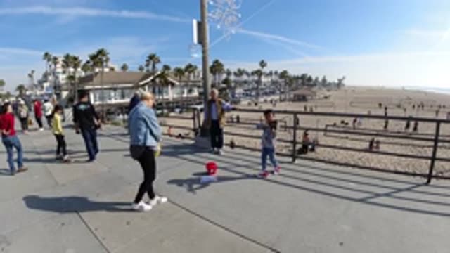 HUNTINGTON BEACH CALIFORNIA-2019: Child And Lady Dance In Slow Motion On