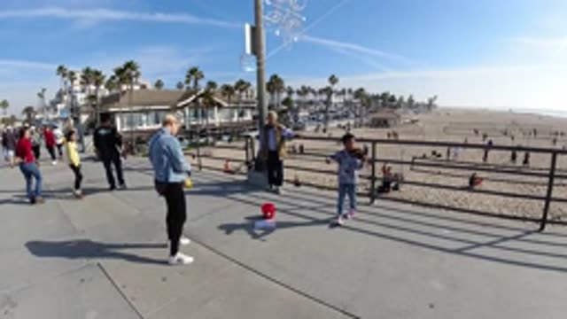HUNTINGTON BEACH CALIFORNIA-2019: Child Doing Show On The Edge Of The Beach And