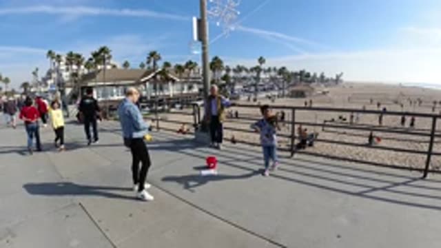 HUNTINGTON BEACH CALIFORNIA-2019: Kid Plays Violin On The Pier
