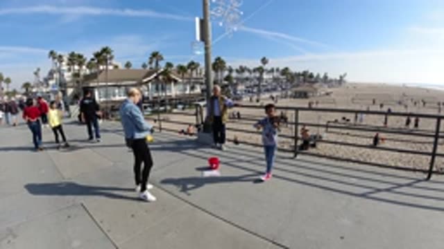 HUNTINGTON BEACH CALIFORNIA-2019: A Child Doing A Musical Performance On The Beach