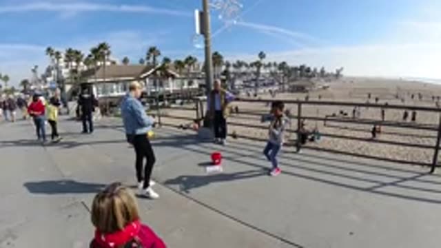 HUNTINGTON BEACH CALIFORNIA-2019: Child Playing Violin On The Beach To Earn