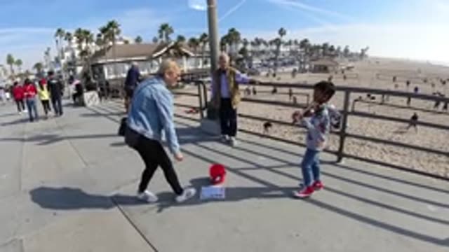 HUNTINGTON BEACH CALIFORNIA-2019: Slow Motion Reversing Of The Child Playing An Instrument