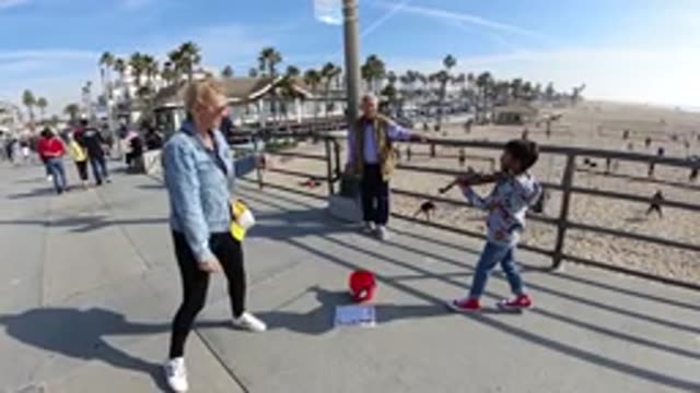 HUNTINGTON BEACH CALIFORNIA-2019: A Slow Motion Picture Of A Kid Playing Violin