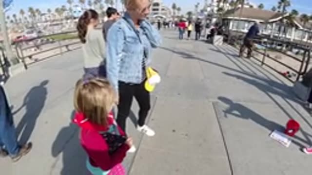 HUNTINGTON BEACH CALIFORNIA-2019: Mom And Daughter Walking Along A Beach