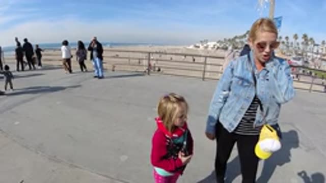 HUNTINGTON BEACH CALIFORNIA-2019: Woman And Girl Walking A Boardwalk Near The