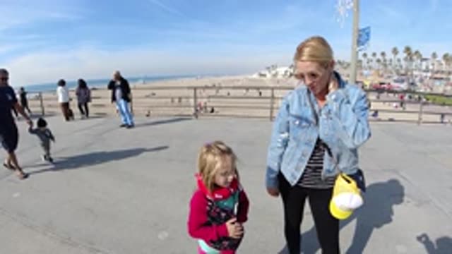 HUNTINGTON BEACH CALIFORNIA-2019: Loving Mom Wearing Blue Jacket Chill With Her Daughter