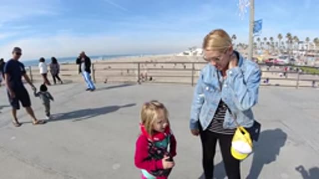 HUNTINGTON BEACH CALIFORNIA-2019: Mom And Daughter Walking Along A Beach