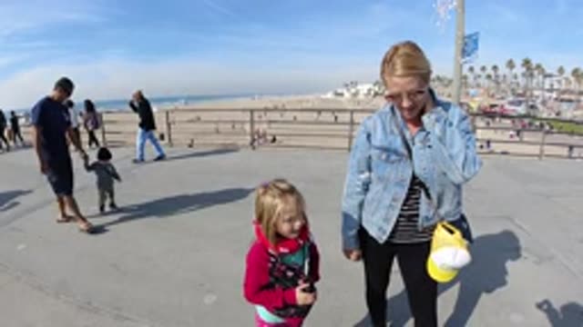 HUNTINGTON BEACH CALIFORNIA-2019: Child Has Fun Playing With His Mother During A
