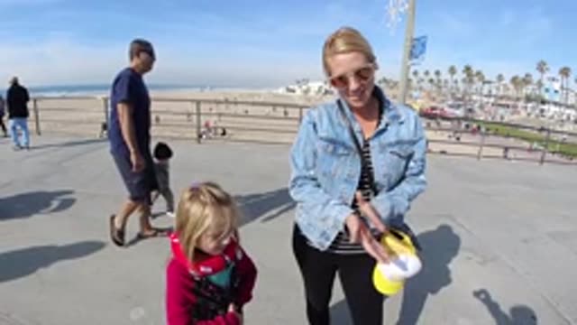 HUNTINGTON BEACH CALIFORNIA-2019: Mom With Daughter Clapping Hands On Santa