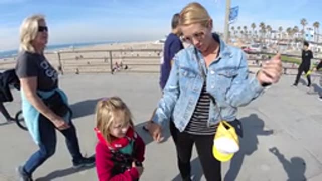 HUNTINGTON BEACH CALIFORNIA-2019: Mom And Daughter Standing On The Shore Of The