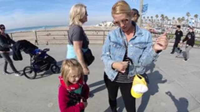 HUNTINGTON BEACH CALIFORNIA-2019: Slow Motion Woman On Walkway Playing Air Guitar