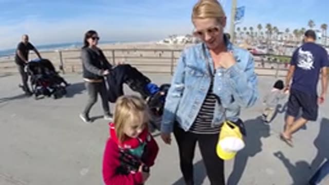 HUNTINGTON BEACH CALIFORNIA-2019: Mom And Daughter Standing At The Beach On A Sunny Day
