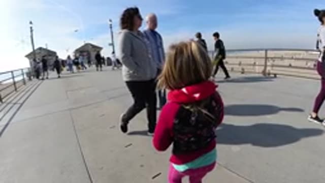 HUNTINGTON BEACH CALIFORNIA-2019: Young Girl Child On A Pier Boardwalk At The