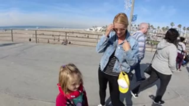 HUNTINGTON BEACH CALIFORNIA-2019: Child Has Fun Playing With His Mother During A