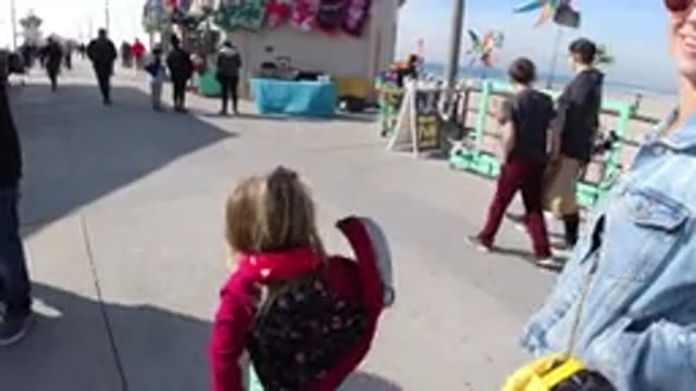 HUNTINGTON BEACH CALIFORNIA-2019: Child Has Fun Playing With His Mother During A