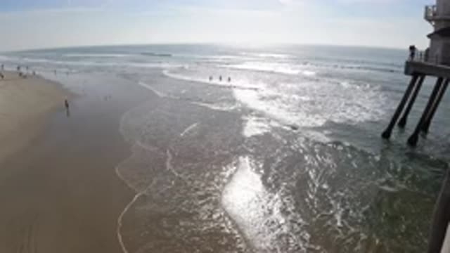 HUNTINGTON BEACH CALIFORNIA-2019: Sea Water Lapping Against A Sandy Shore On A
