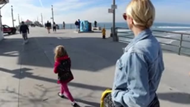 HUNTINGTON BEACH CALIFORNIA-2019: Family Roaming Around The Pier On A Sunny Day