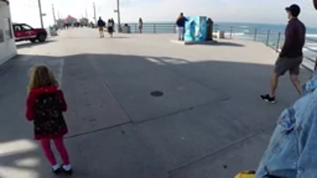 HUNTINGTON BEACH CALIFORNIA-2019: The People Taking A Walk On A Bright Warm Afternoon