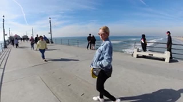 HUNTINGTON BEACH CALIFORNIA-2019: Many People Strolling in the Park and a Woman