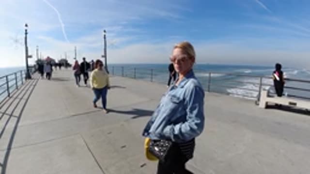 HUNTINGTON BEACH CALIFORNIA-2019: Woman At The Beach Walking On A Dock On A