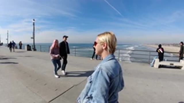 HUNTINGTON BEACH CALIFORNIA-2019: A Woman Taking Picture On The Pier Of A