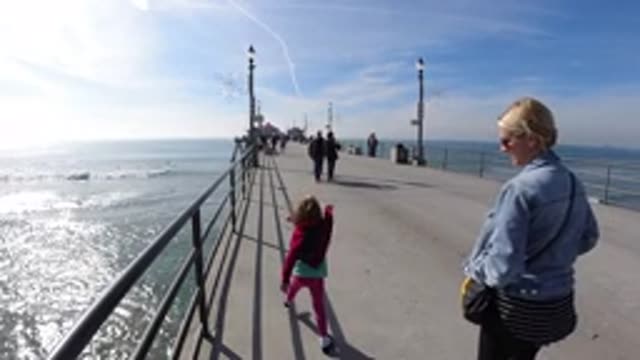 HUNTINGTON BEACH CALIFORNIA-2019: Blonde Woman Walking on Pier