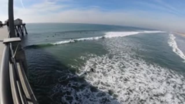 HUNTINGTON BEACH CALIFORNIA-2019: Enjoying Ocean Breeze And Waves From The Dock