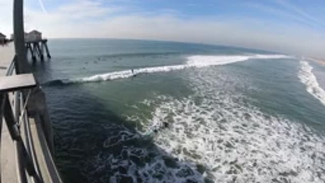 HUNTINGTON BEACH CALIFORNIA-2019: Pier Over Water Turbulent Current Waves