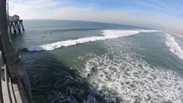 HUNTINGTON BEACH CALIFORNIA-2019: Aerial View Of Big White Wave Crashing On Shore