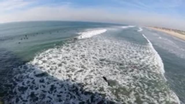 HUNTINGTON BEACH CALIFORNIA-2019: Waves Crashing On A Beach As Seen From A Pier
