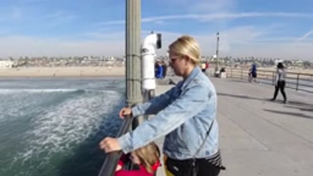 HUNTINGTON BEACH CALIFORNIA-2019: Family Watching The Beauty Of The Sea From A