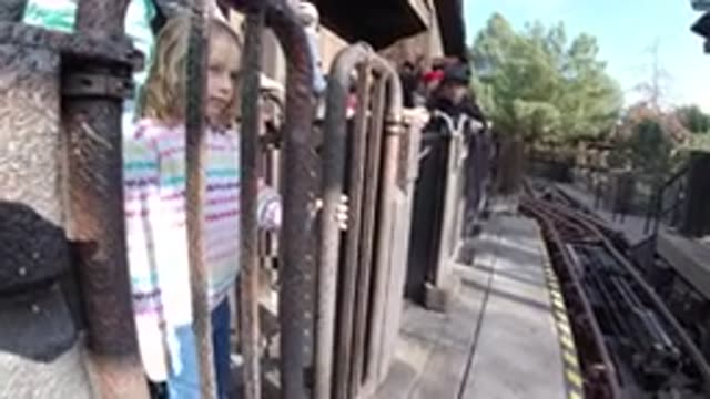HUNTINGTON BEACH CALIFORNIA-2019: Cute Little Girl Playing And Try To Fit Into A Metal Gate