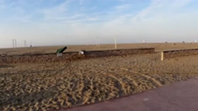 HUNTINGTON BEACH CALIFORNIA-2019: A Person Building a Small Wall in a Grassland