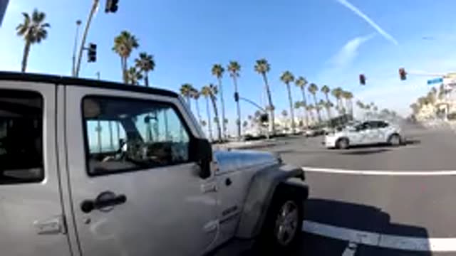 HUNTINGTON BEACH CALIFORNIA-2019: Time Lapse Of Cars Driving Down A Road Lined With Palm Trees