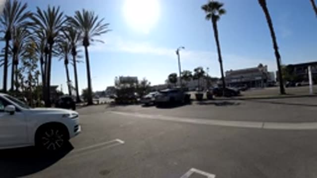 HUNTINGTON BEACH CALIFORNIA-2019: Sped Up Cards On Road Surrounded By Palm Trees