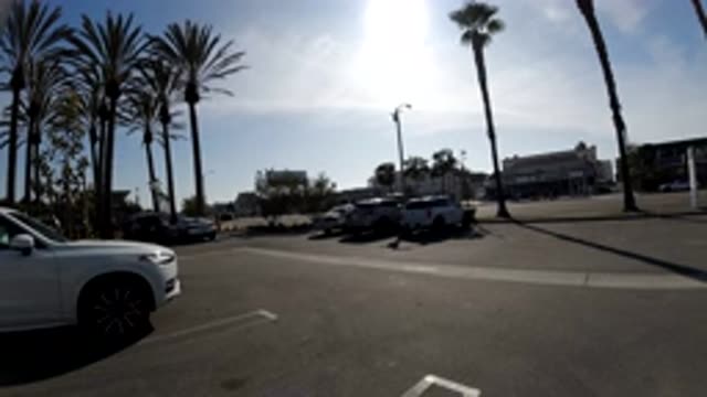 HUNTINGTON BEACH CALIFORNIA-2019: White Car In A Parking Lot While The Cars In