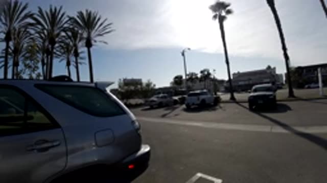 HUNTINGTON BEACH CALIFORNIA-2019: Cars Driving In A City With Trees And Sun And