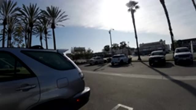 HUNTINGTON BEACH CALIFORNIA-2019: Silver SUV Backs Out Of Parking Space And