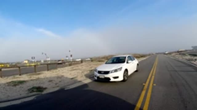 BOLSA CHICA CALIFORNIA-2019: A Time Lapse Of A Car Going Down A Road And Then