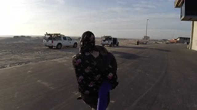 BOLSA CHICA CALIFORNIA-2019: The Woman Carries Her Baby To The Military