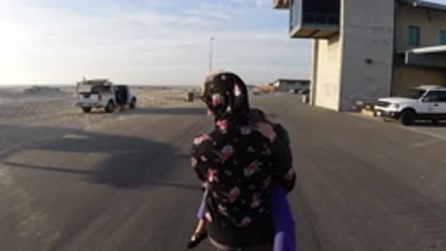 BOLSA CHICA CALIFORNIA-2019: Muslim Woman Carrying Child Down A Street