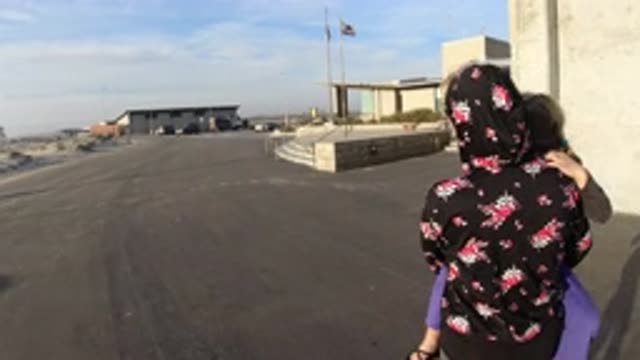 BOLSA CHICA CALIFORNIA-2019: Mother With A Baby Girl On Her Shoulders In A Parking Lot