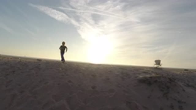BOLSA CHICA CALIFORNIA-2019: Girl Playing In The Sand On The Beach