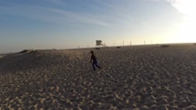 BOLSA CHICA CALIFORNIA-2019: Child Has Fun Playing With His Father During A Walk