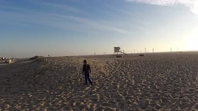 BOLSA CHICA CALIFORNIA-2019: Little Girl Playing On The Sand At The Beach