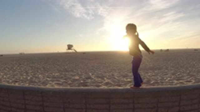 BOLSA CHICA CALIFORNIA-2019: Child Playing To Balance Himself In A Park Full Of