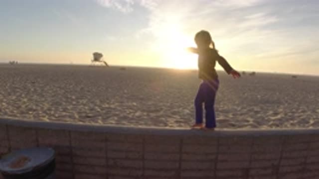 BOLSA CHICA CALIFORNIA-2019: Little Girl Playing In The Sand At The Beach