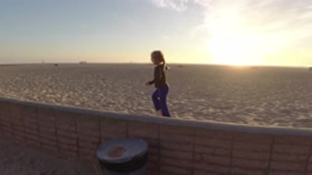BOLSA CHICA CALIFORNIA-2019: Little Girl Running And Playing In Sand Near Beach